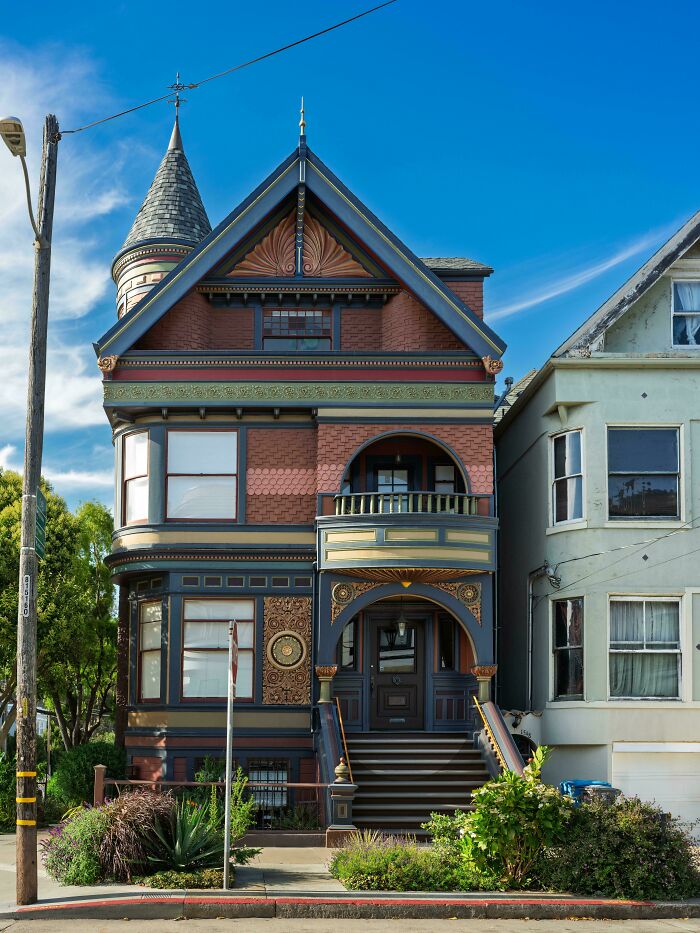 Vibrant Victorian architecture with a tower and detailed facade, showcasing beautiful architecture.