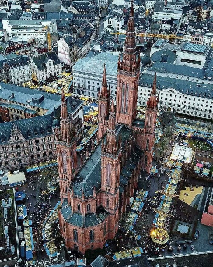 Aerial view of a grand church in a bustling city center, highlighting the beautiful architecture.