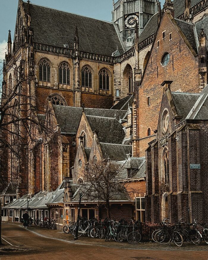 Historic European architecture with a tall church and brick buildings, showcasing beautiful architecture.