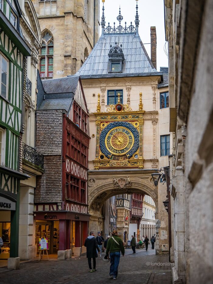 Historic architecture with a large ornate clock and archway, illustrating beautiful architectural details.