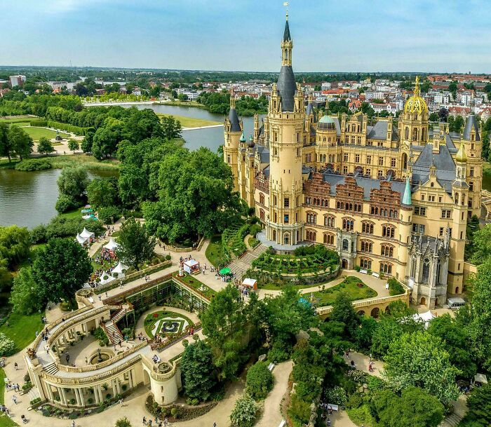 Aerial view of Schwerin Castle, a stunning example of beautiful architecture surrounded by lakes and gardens.