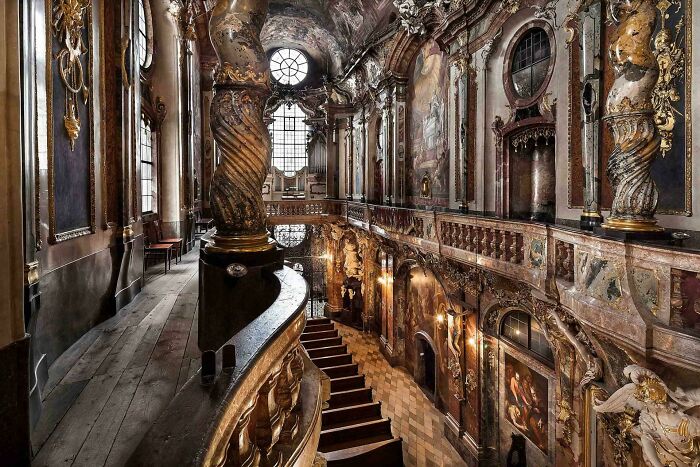 Ornate baroque architecture interior with grand staircase, intricate details, and beautiful design.