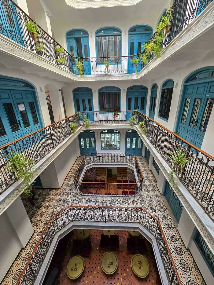 Stunning architecture with blue doors and balconies around a central courtyard, a beautiful example.