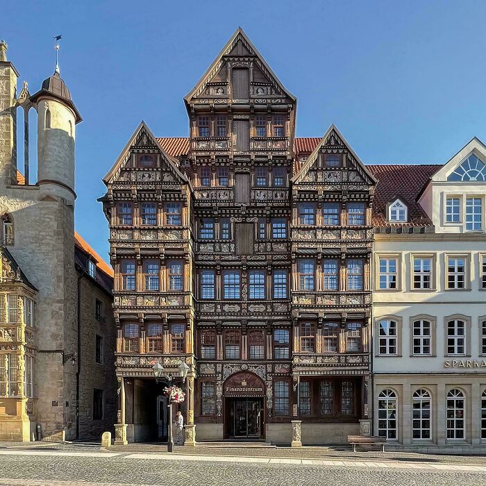 Intricately carved timber-frame architecture, a beautiful and historic building on a sunny day.