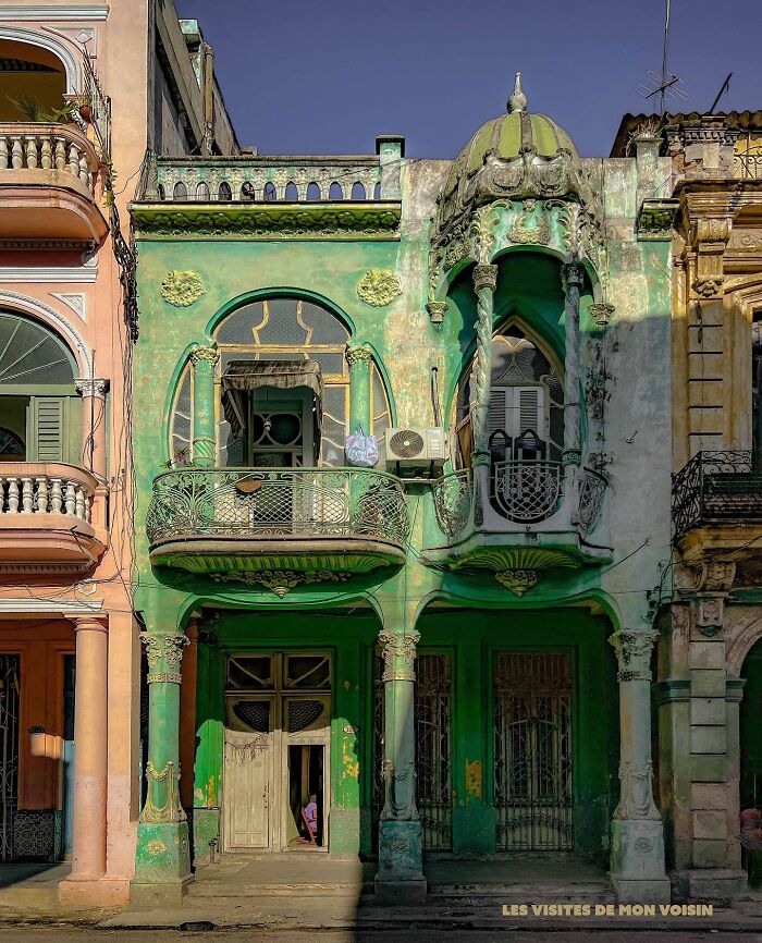 Vibrantly green, ornate architecture with decorative balconies, showcasing beautiful design in Havana.
