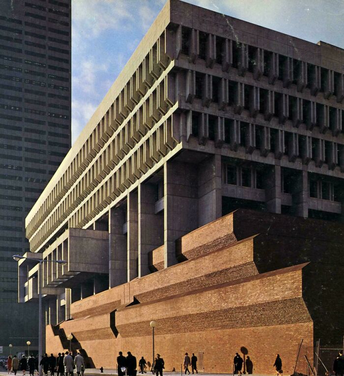 Brutalist architecture building with tiered brick base and concrete facade, a beautiful example.