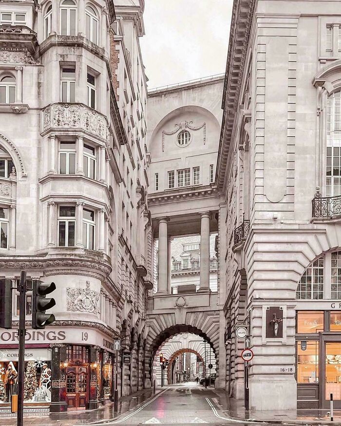 Beautiful architecture featuring a street with arched walkways and ornate buildings, showcasing unreal details.