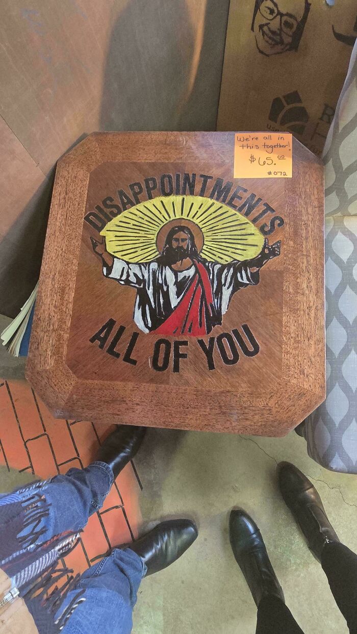 Wooden thrift store table with painted image and text, featuring thrift store finds that feel like stumbling upon a pot of gold.