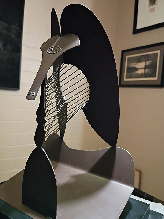 Abstract modern metal sculpture thrift store find displayed indoors with artistic design and string details, a unique vintage treasure.