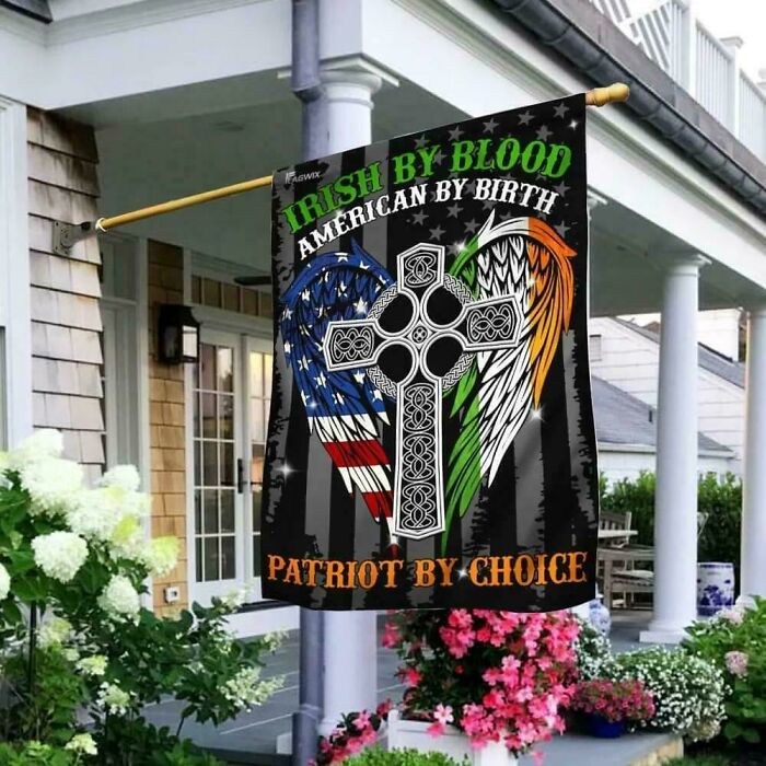A flag outside a house that reads Irish by blood, American by birth, patriot by choice with a Celtic cross.