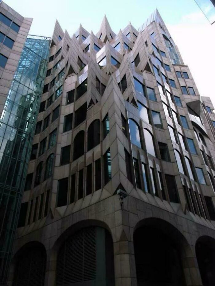 A modern building with sharp, pointed architectural features, looking like a base for an evil mastermind.
