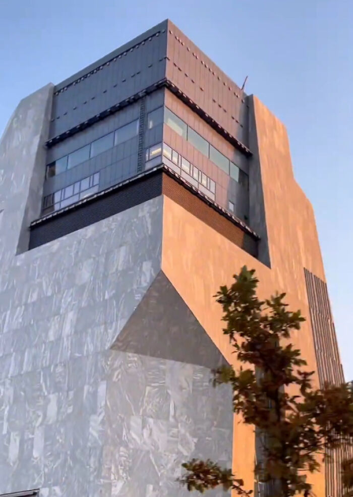 Modern, imposing buildings with unique architecture under a clear sky, fitting an evil mastermind's lair.