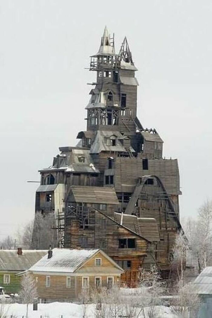 A tall, ramshackle wooden building, potentially an evil mastermind's lair, in a snowy landscape.