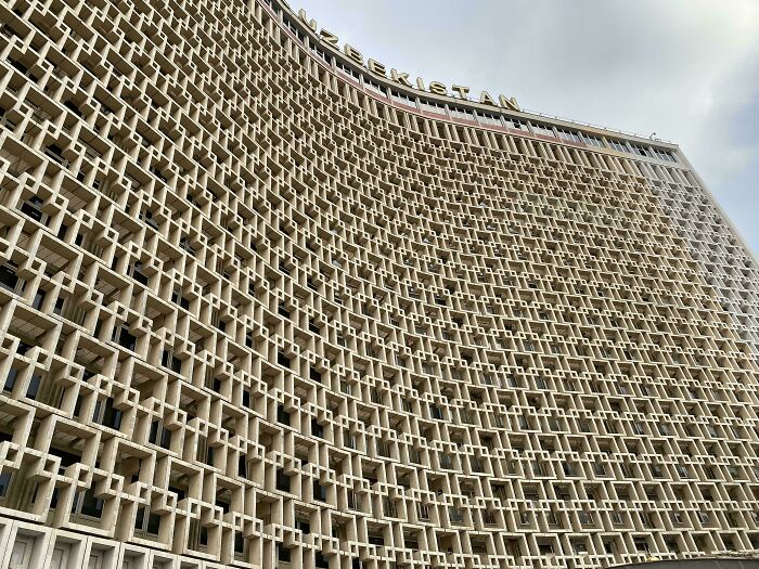 An old, imposing building with an intricate, repeating pattern on its facade, suitable for an evil mastermind.