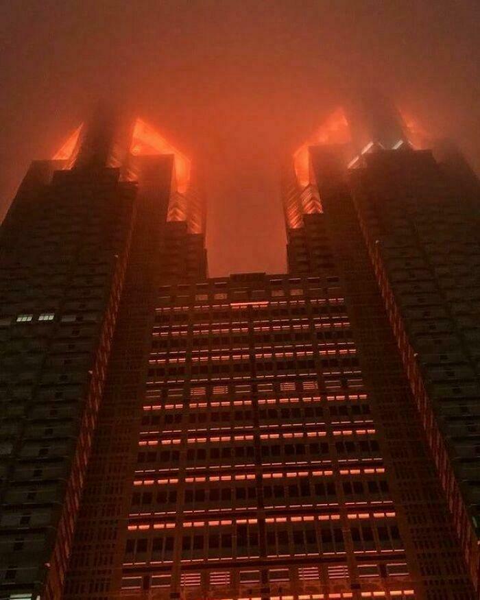 Foreboding red-lit building shrouded in mist, a perfect lair for an evil mastermind to conquer the world.