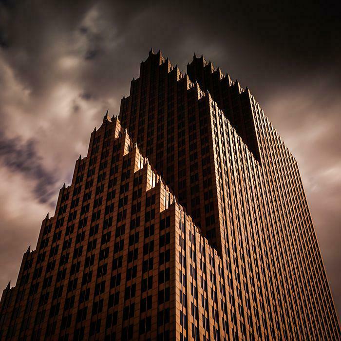 A unique, angular building under a dramatic sky, evoking the architectural style of an evil mastermind's lair.