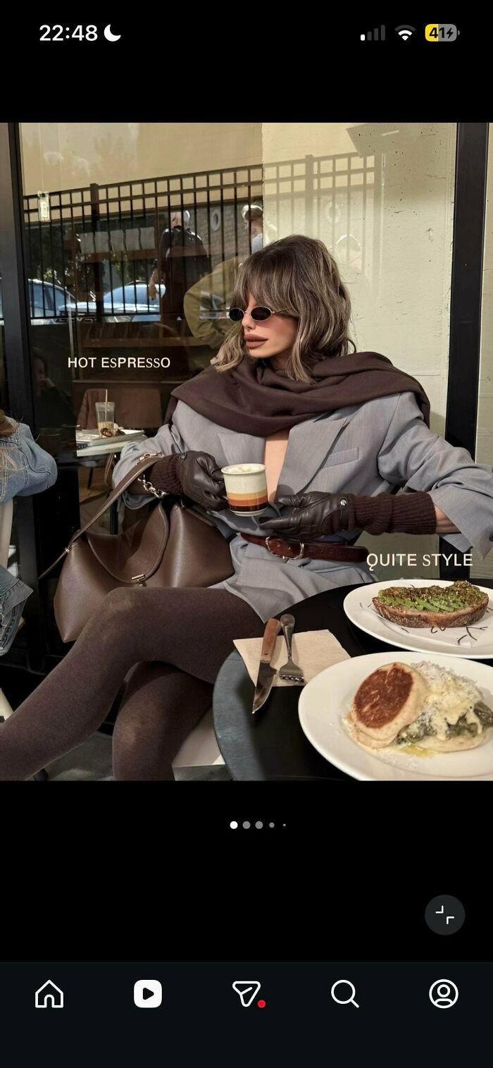 A woman on social media posing with a cup of espresso, looking quite unnatural in her pose at a cafe.