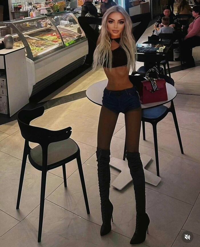 A digitally altered woman with an exaggeratedly thin waist and long legs in a cafe, appearing unnatural on social media.