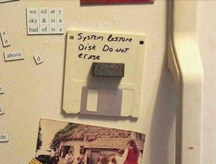 A floppy disk labeled System Restore Disk Do Not Erase, a geeky piece of technology on a fridge.