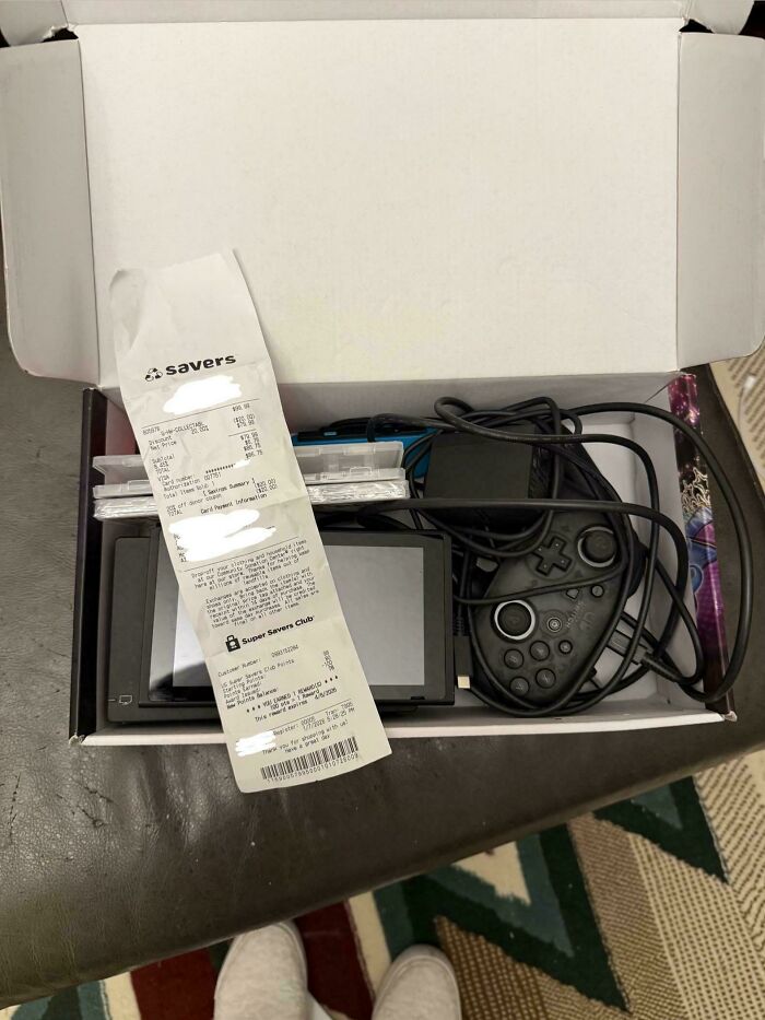 A Nintendo Switch console and accessories, a thrift store jackpot, unpacked from a box with a receipt.