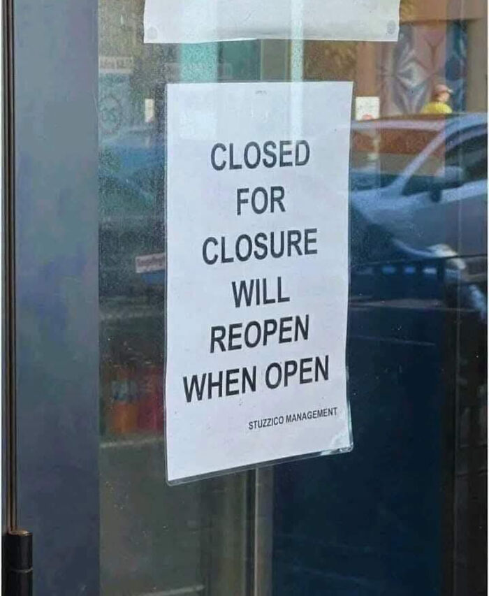 Sign on a glass door humorously stating closed for closure and will reopen when open, a bizarre and absurd sign.