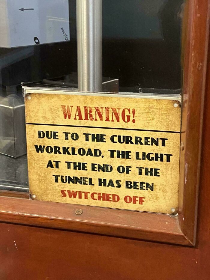 Warning sign humor about workload saying the light at the end of the tunnel has been switched off, bizarre and hilarious signs.