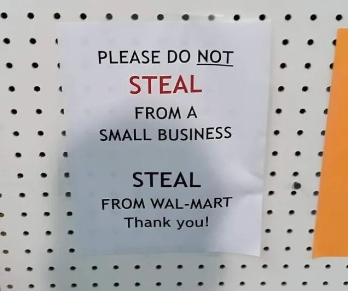 Absurd sign asking people not to steal from a small business but to steal from Walmart instead, displayed on a pegboard.