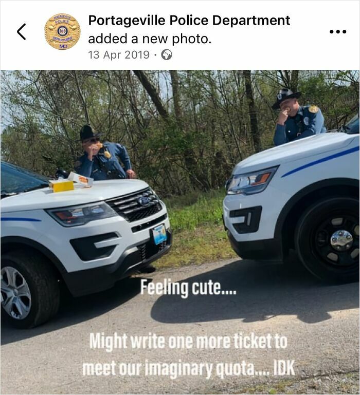 Two police officers casually leaning on police cars with humorous social media caption about writing an imaginary ticket.