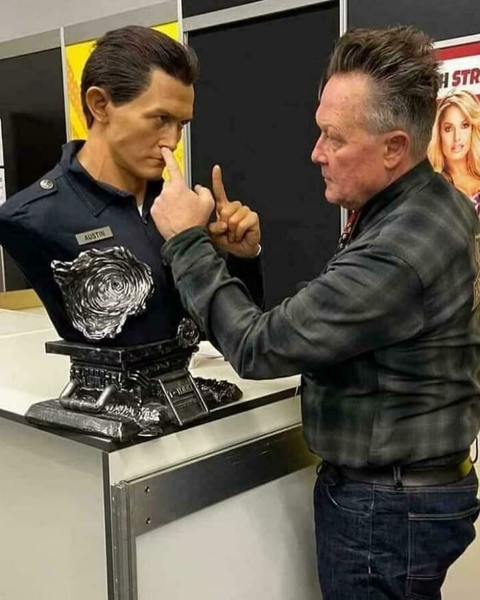 Man playfully interacting with a science fiction bust labeled Austin, highlighting funny and relatable memes for sci-fi nerds.