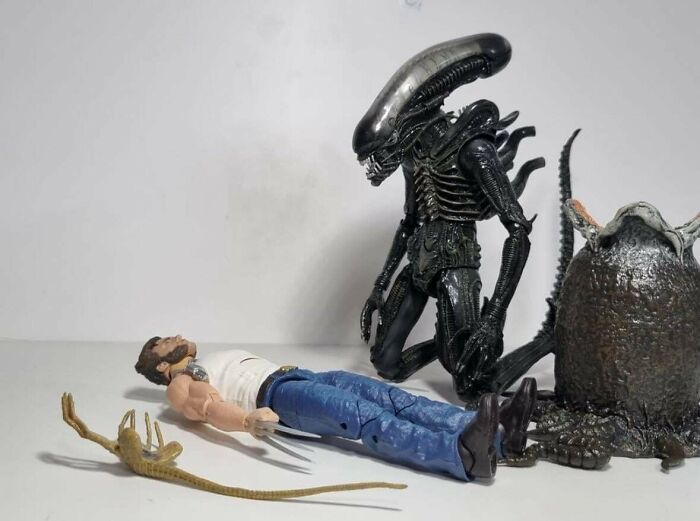 Alien figure looming over action figures of a man and sci-fi creatures, fitting for science fiction nerds memes content.