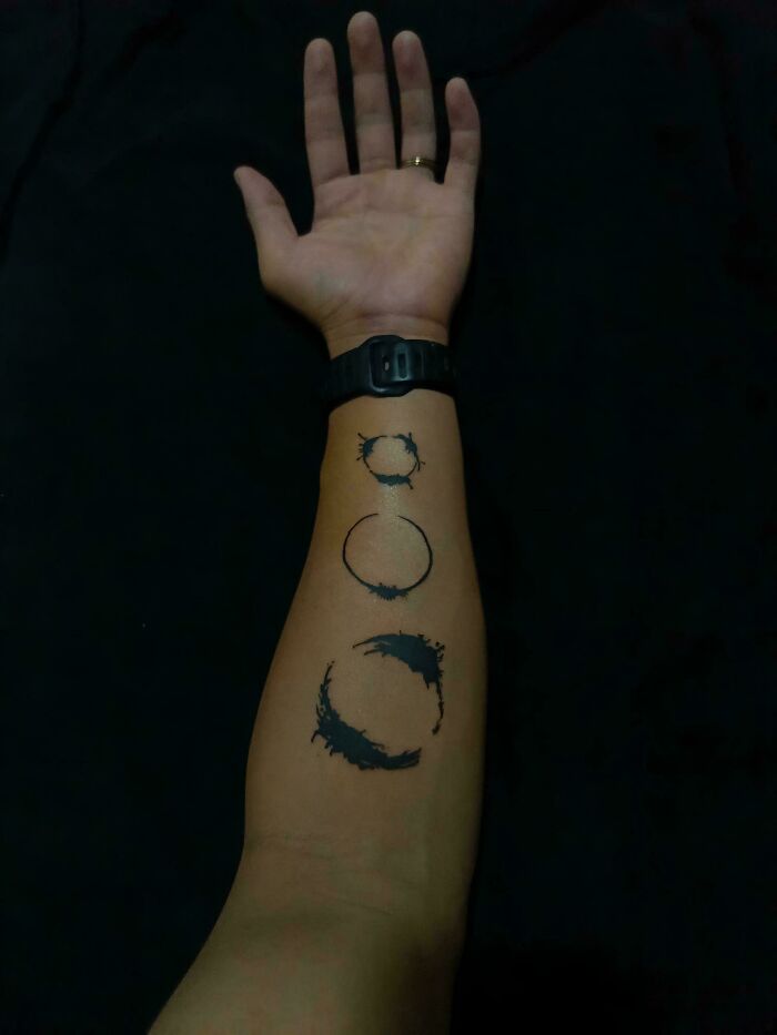 Forearm tattoo with three abstract circular designs, suitable for science fiction nerds enjoying funny and relatable memes.