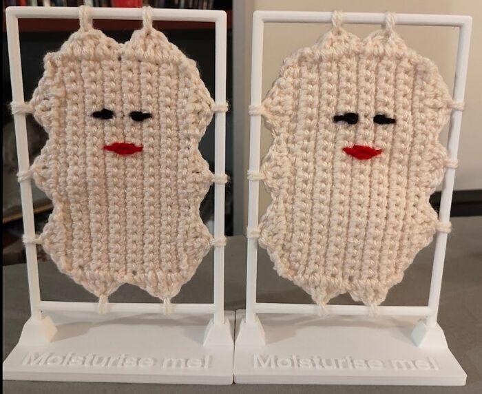 Two crocheted faces with red lips on white stands, labeled "Moisturise me!". Awesome crocheted craft.