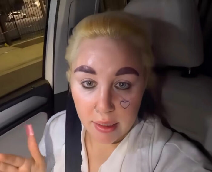 Amanda Bynes with heart tattoo on her face, raising concern among fans about child stars and mental health struggles.