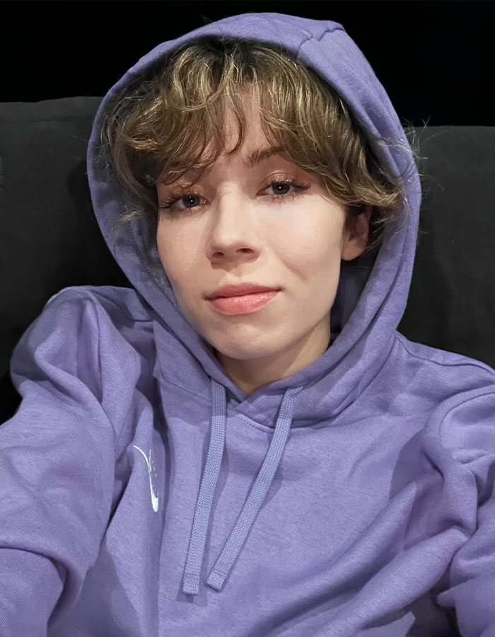 Jennette McCurdy wearing a purple hoodie, looking at the camera in a casual selfie about her addictive relationship.
