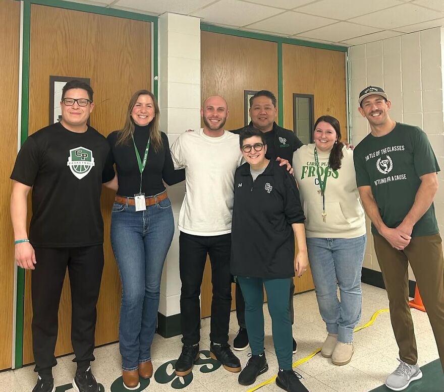 Group of coworkers smiling indoors, illustrating the challenges of jobs with poor work-life balance and disaster risks.