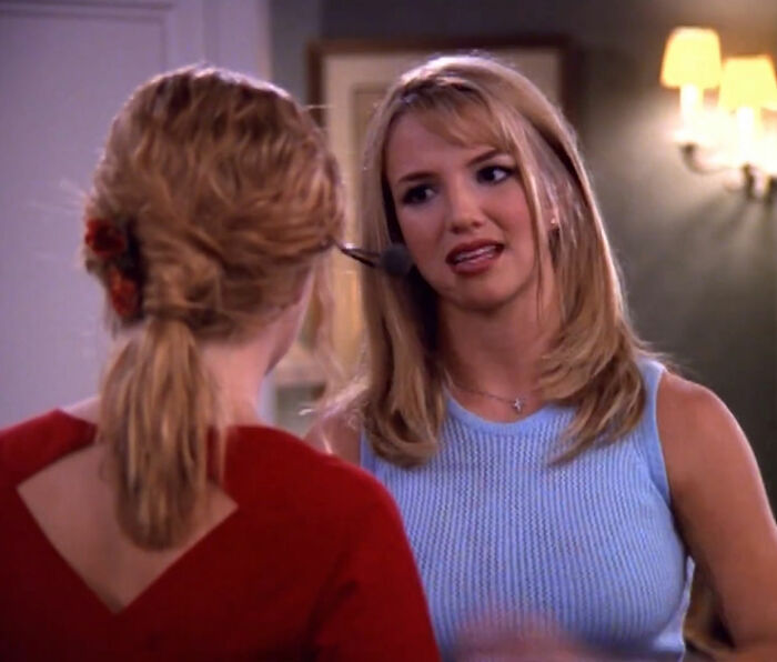 Nickelodeon star with headset talking to another woman, revealing humiliating reason for crying near Britney Spears photo.