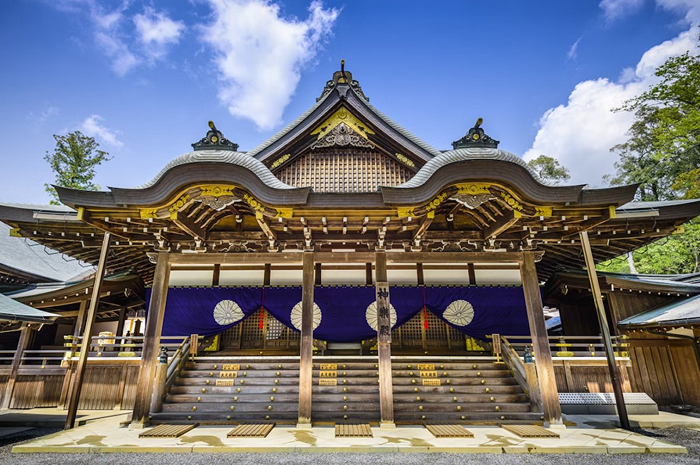 Traditional Japanese shrine with intricate wooden architecture under a bright sky, a forbidden place many will never visit.