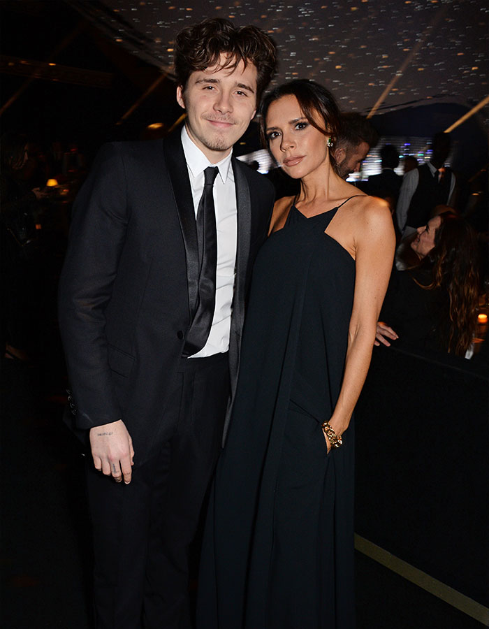 Brooklyn and Victoria Beckham posing together at an event, spotlight on Victoria Beckham dance footage controversy.