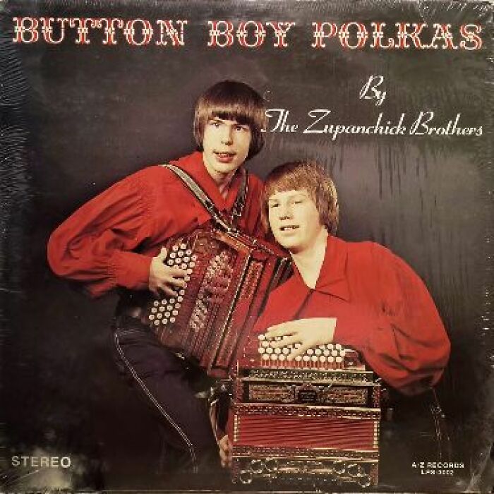 Two young men in red shirts posing with accordions on a hilariously bad album cover from the 1970s.