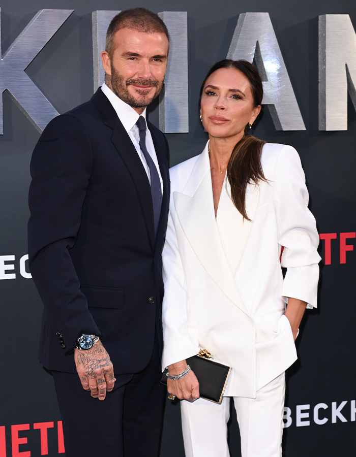 David and Victoria Beckham posing together at a formal event with focus on Beckham family prenup news.