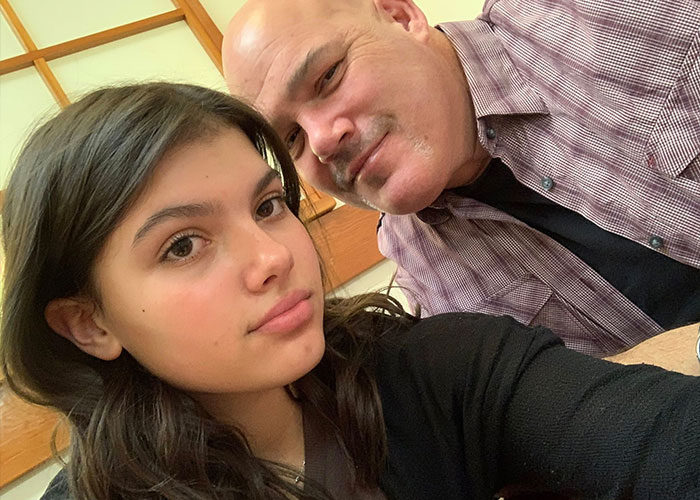 Teen girl and man posing closely together indoors, highlighting autopsy results uncover startling clues in Canadian teen case.