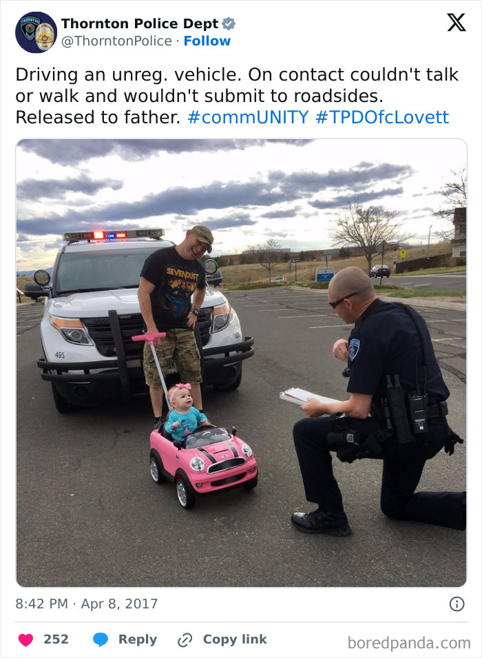 Police social media post shows officer humorously interacting with toddler in a toy car, highlighting unserious police social media accounts.