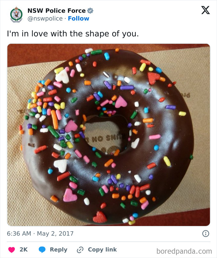 Chocolate frosted donut with colorful heart and sprinkle toppings shared by police social media account in a humorous post.