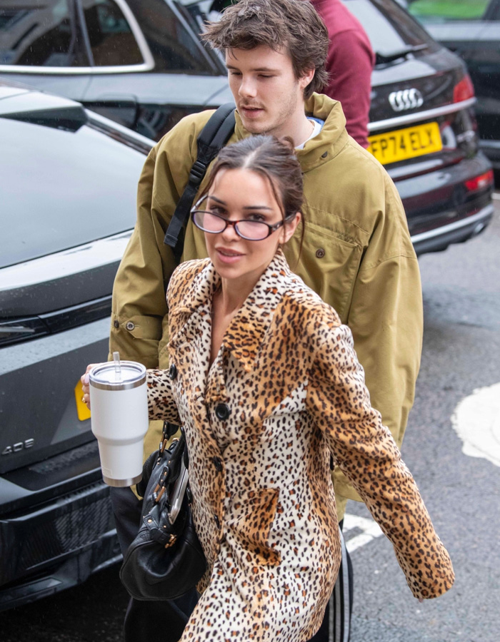Cruz Beckham and his mom lookalike girlfriend walking on city street, sparking buzz about how old she is.