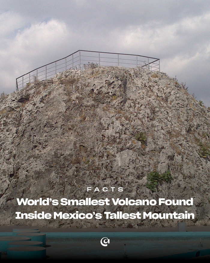Small rocky volcanic mound with metal railing and cloudy sky, illustrating fun facts about Mexico