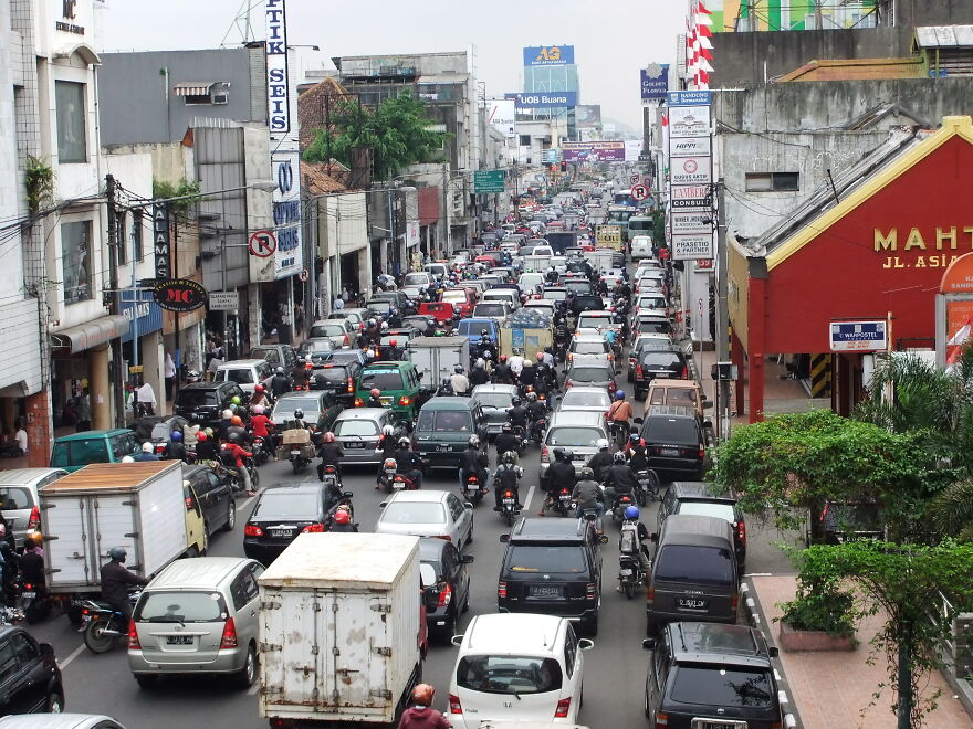 Heavy traffic congestion with cars and motorcycles on a busy urban street in one of the cities with worst traffic.