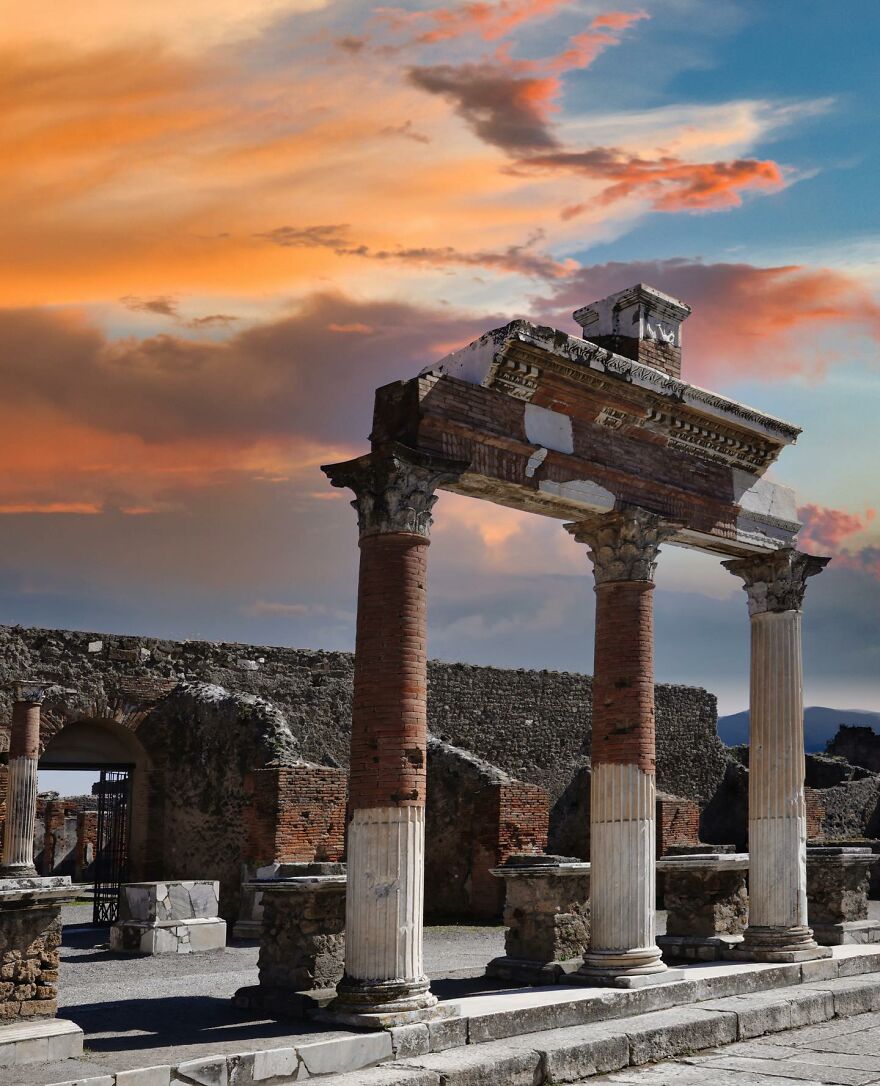 Ancient ruins with classical columns under a colorful sunset sky, a must-see place you should visit at least once.