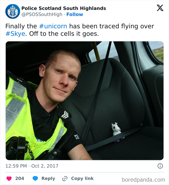 Police officer selfie with a toy unicorn secured by a seatbelt, showcasing one of the funniest police social media accounts.