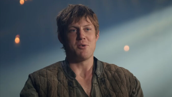 Peter Claffey dressed as Ser Duncan The Tall, wearing medieval attire with soft lighting in a dramatic scene.