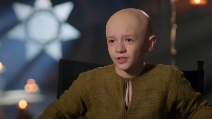 A Knight of the Seven Kingdoms actor speaking in an interview setting, discussing plans to avoid Stranger Things problem.